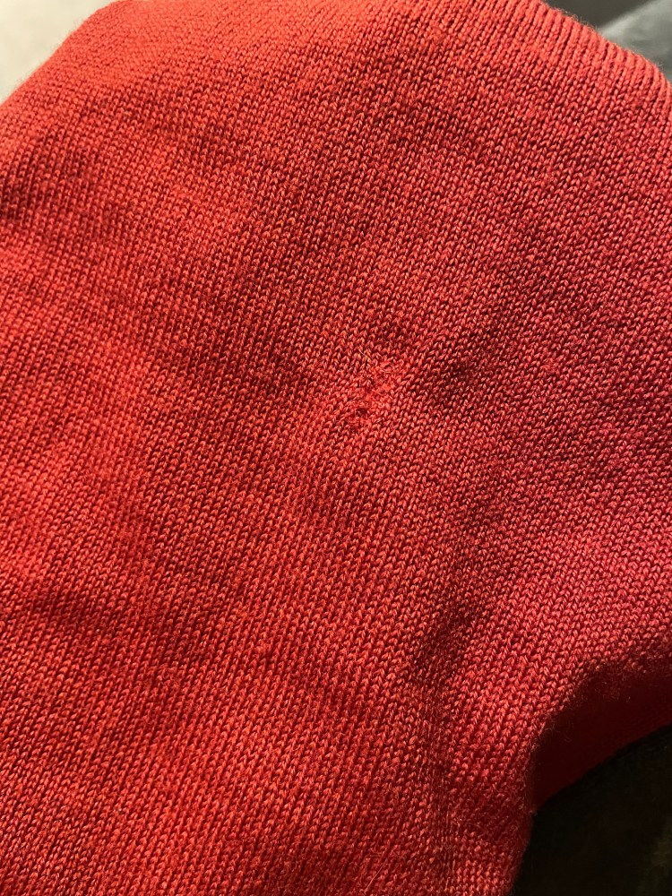 detailed shot of a hole having been hand sewn repaired